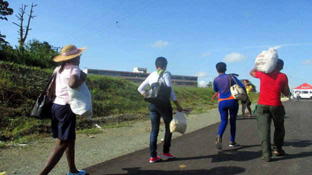 A group of people carry bags with food products specially offered for the arrival of Pope Francis. (Donate Fernando Ochoa)