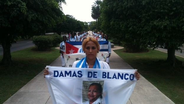 Ladies in White during their traditional Sunday march down Fifth Avenue in Havana. The banner shows Laura Pollán, a co-founder of the organization whose death has never been adequately explained (Angel Moya)