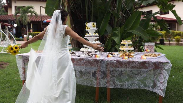A bride looks at the multi-tiered cake designed for her wedding. (DC)