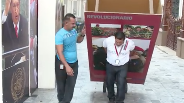 Photographs of former President Hugo Chavez being removed from Parliament. (Youtube)