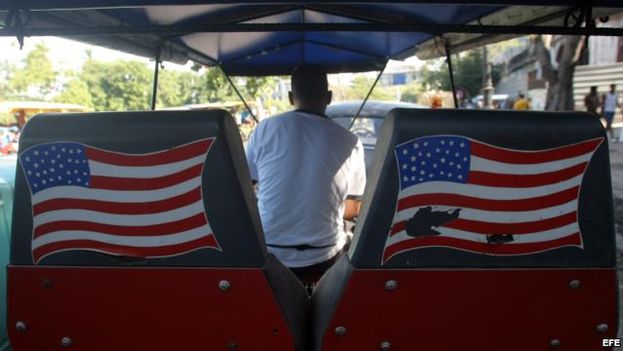 A man pedaling a pedicab with the American flag through the streets of Havana. (EFE)